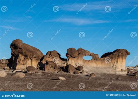 Surreal Sculpted Rock Formation with Natural Window Under a Blue Sky Stock Image - Image of ...