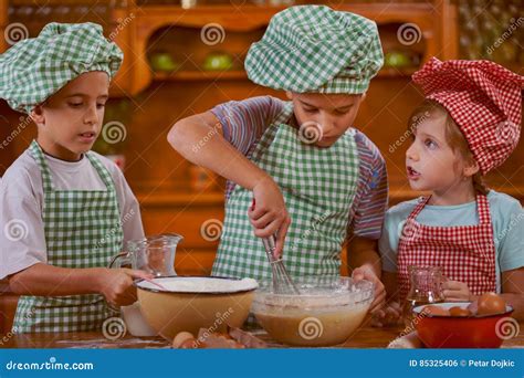 Smiling Kids Making Mess In The Kitchen At Home Stock Photo Image Of