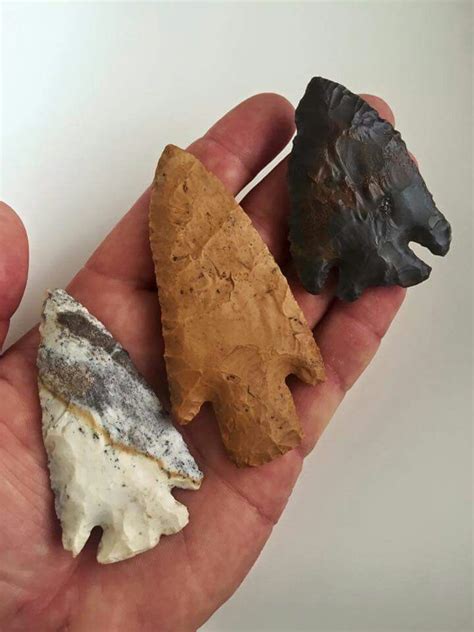 A Hand Holding Three Different Types Of Rocks