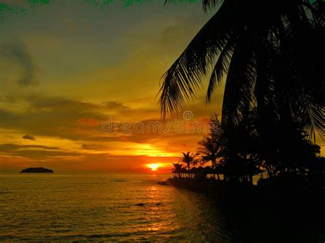 Fiery Glow Sunset Over A Beautiful Tropical Beach And Ocean Water