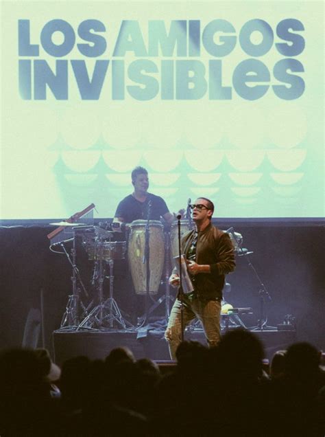 Two Men Standing On Stage With Drums In Front Of Them And The Words Los