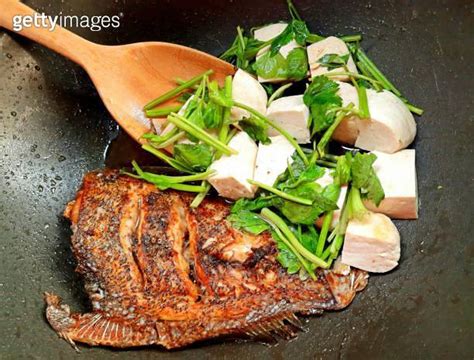 Cooking Deep Fried Halibut Fish With Tofu And Celery In Brown Sauce