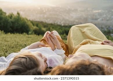 Holding Hands Grass Sunset Photos and Images | Shutterstock