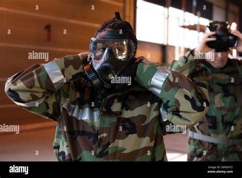 A U S Air Force Airman Inspects Her Gas Mask To Ensure A Proper Seal