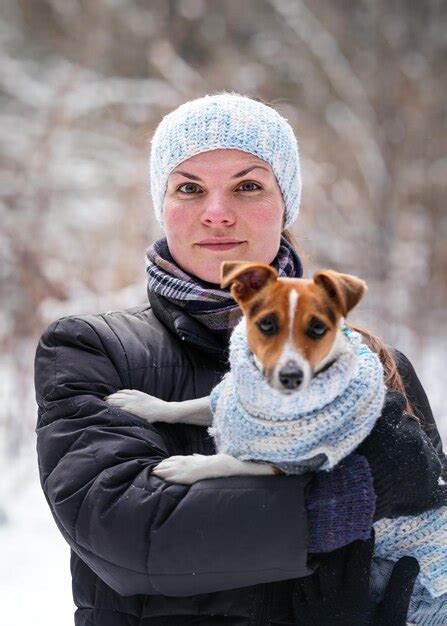 Premium Photo Young Woman In Winter Jacket Holding Her Jack Russell