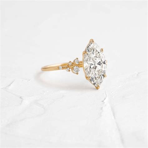 Snowdrift Ring With A Marquise Cut Diamond And Cluster Band