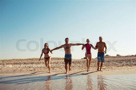 Friends on the beach. Have fun at sunny summer day | Stock image | Colourbox