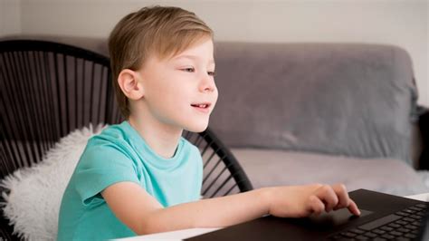 Free Photo Child Using His Laptop Indoors