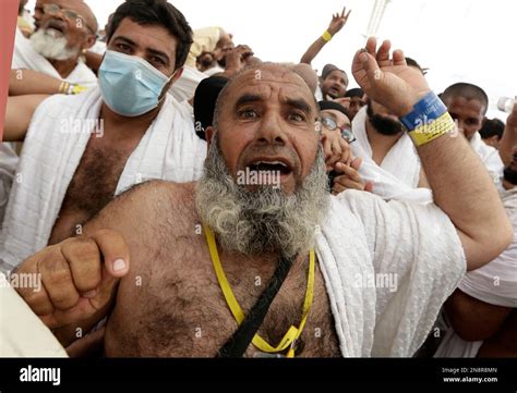 Muslim Pilgrims Cast Stones At A Pillar Symbolizing The Stoning Of