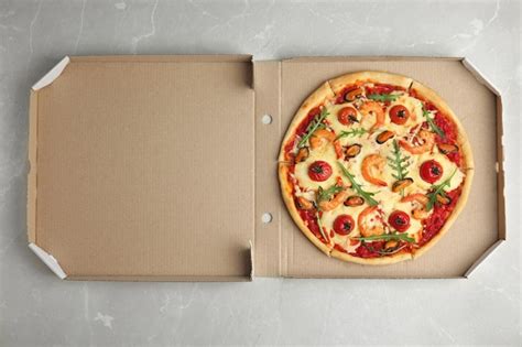 Premium Photo Delicious Seafood Pizza In Cardboard Box On Grey Marble