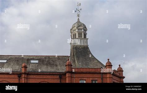 View Of The Roof Of A Building With Ornate Weather Vane And Made Out Of