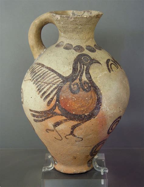 an old vase with a bird painted on it