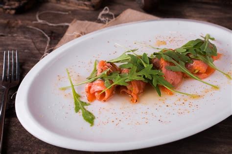 Premium Photo Fresh Sliced Salmon Fillet With Arugula On White Plate