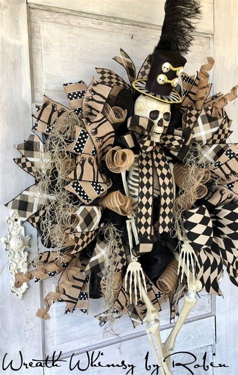 a skeleton wreath is hanging on the front door with black and white ...