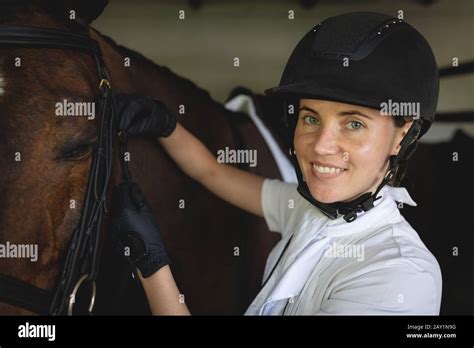 Woman Preparing Her Dressage Horse In A Stable Stock Photo Alamy