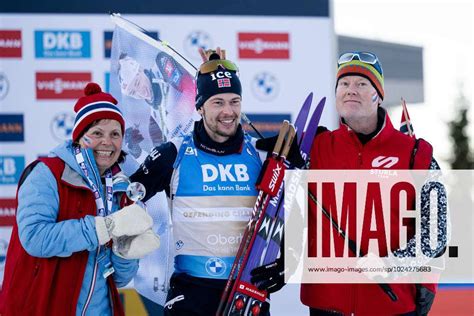 230214 Sturla Holm Laegreid Of Sweden With His Parents After Mens 20 Km