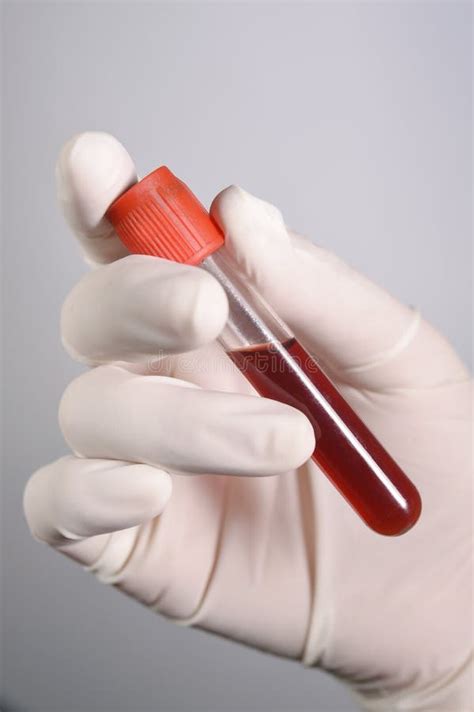 Hand Holding Blood In Test Tube Take With Blue Filter Stock Photo