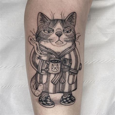 A Black And White Cat Tattoo On The Left Leg With An Image Of A Sailor