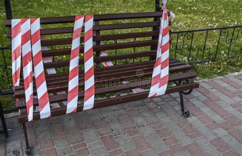 Bench Fenced With Red White Barrier Tape The Access Is Denied During