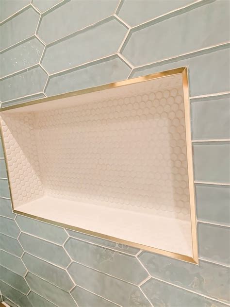 Elegant Shower Niche With Penny Tile And Gold Trim