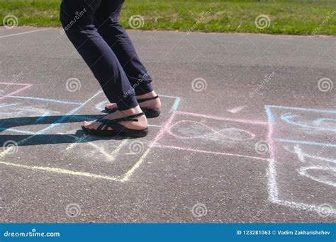 Girl Teenager Jumps Playing Hopscotch In The Street Close Up Legs