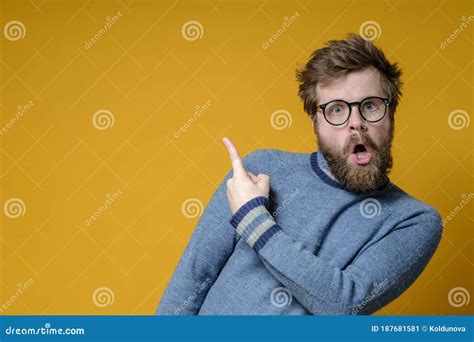 Odd Bearded Man In Glasses Points With An Index Finger To An Empty