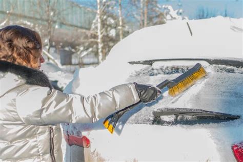 Premium Photo Woman Cleaning Snow From Car Windshield