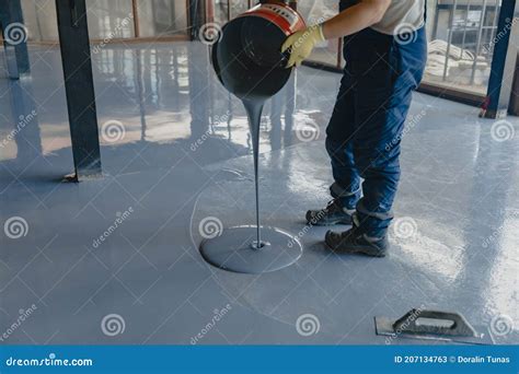 The Worker Applies Gray Epoxy Resin To The New Floor Editorial Stock