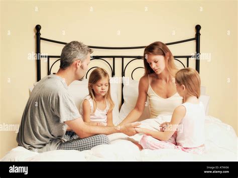 Family praying bed hi-res stock photography and images - Alamy