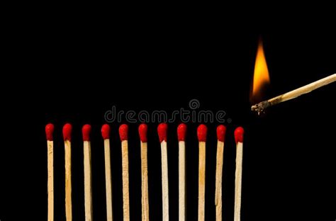 Burning Match With Row Of Matches Isolated On Black Background Stock