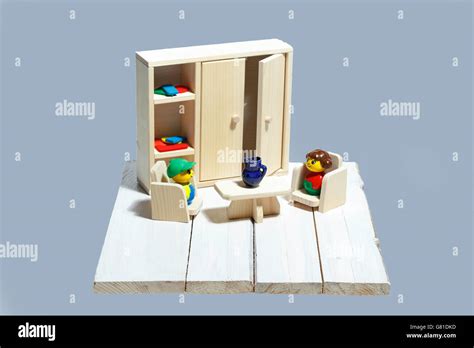 Wooden toy furnitures with colored figurines on a natura wood ...