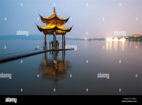 The pagoda in the West Lake of Hangzhou illuminated at night Stock Photo - Alamy