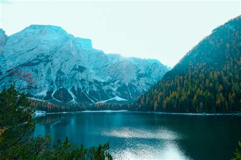 Mirror Lake Reflecting Wooden House In Middle Of Lake Overlooking