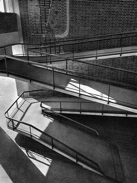 Black And White Photograph Of An Escalator In A Building With Sunlight