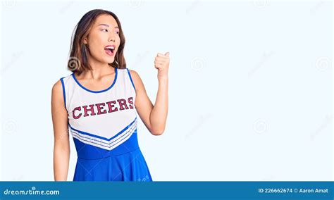 Young Beautiful Chinese Girl Wearing Cheerleader Uniform Smiling With