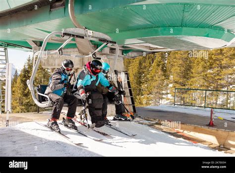 Skiers Getting Off Chair Lift At Sunny Ski Resort Stock Photo Alamy