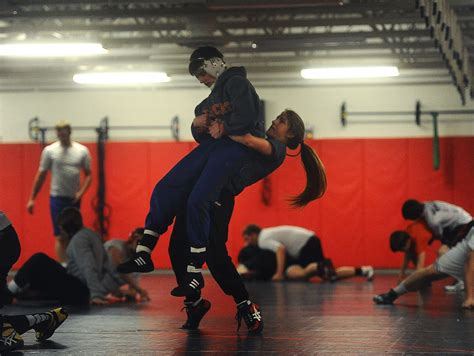 Men Wrestling Women: Female wrestler battles her male teammates at practice