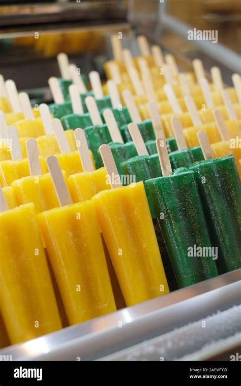 Fresh Natural Pure Fruit Juice Flavoured Ice Lollies On Wooden Sticks