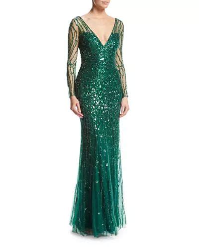 A Woman In A Green Gown With Long Sleeves And Sequins On The Shoulders