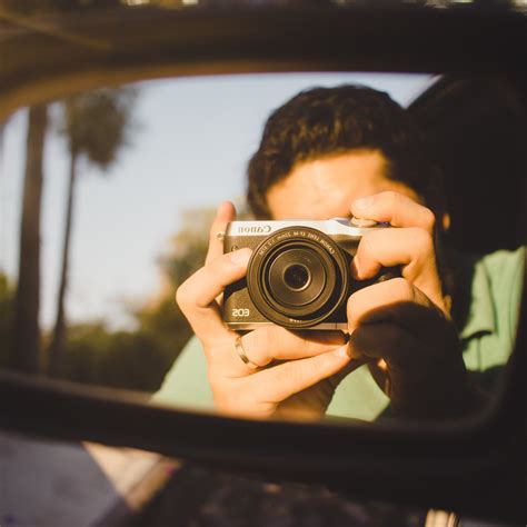 Person Reflect on Round Brown Wooden-framed Mirror · Free Stock Photo