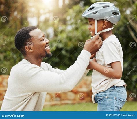 Protecting His Baby A Father Adjusting His Sons Helmet Outside Stock