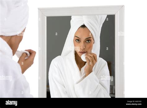 Beautiful Young Woman At Her Beauty Routine Looking At Her Reflection