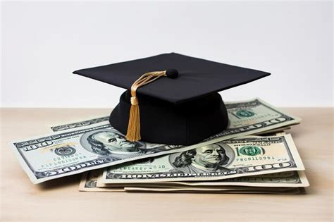 Premium Photo A Stack Of Dollar Bills With A Graduation Cap On Top Of It