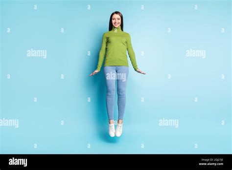 Photo Of Positive Cheerful Lady Jump Have Fun Shy Pose Wear Green