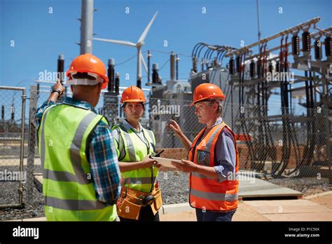 Engineers With Digital Tablet At Sunny Power Plant Stock Photo Alamy