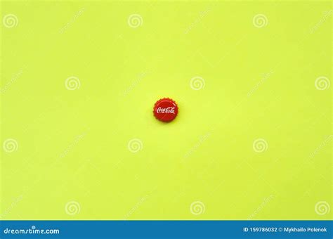 Single Red Bottle Lid with Coca Cola Logo on Yellow Background ...