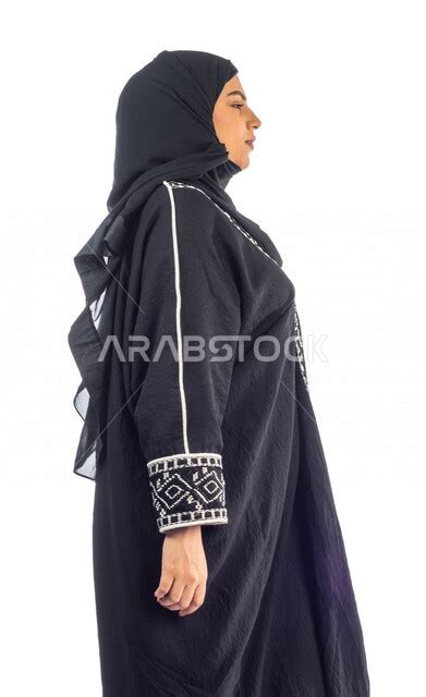 Side View Of A Saudi Arabian Gulf Woman Wearing An Abaya And Hijab