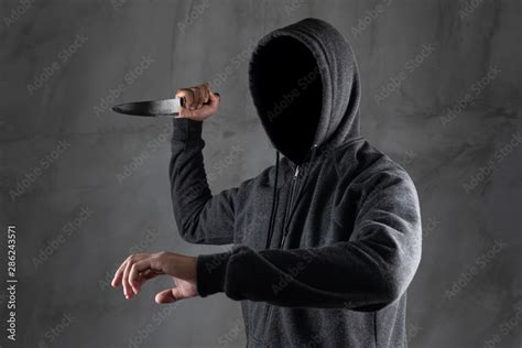 Dangerous Hooded Man Standing In The Dark And Holding A Knife Face Can