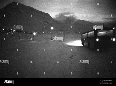 1969 Svalbard, Longyearbyen. A bus runs in the polar night in ...