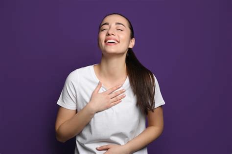 Premium Photo | Beautiful young woman laughing on purple background ...